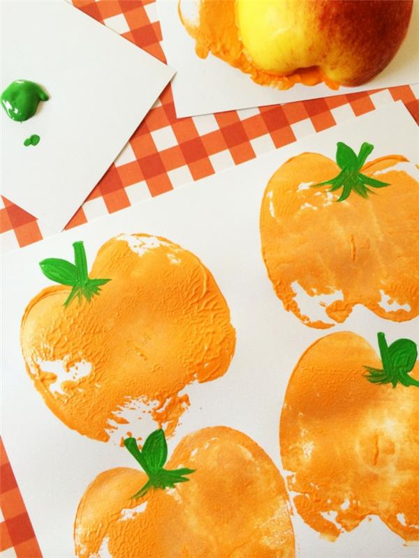 Jesenski otrok DIY z risanjem bučk v oranžnih odtisih jabolk, jesenska ročna dejavnost v vrtcu