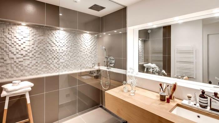 kopalnica z italijansko prho s steno iz rjave ploščice in leseno omarico za umivalnik v švedskem stilu