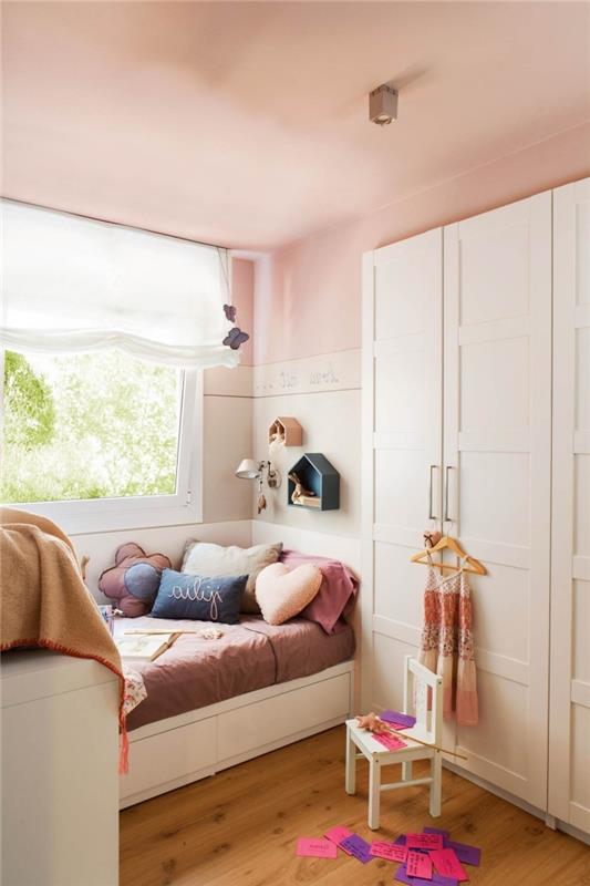 ahşap mobilyalarla döşenmiş pastel pembe yatak odası, pembe duvarlar ve ahşap zemin ile örnek küçük kız yatak odası