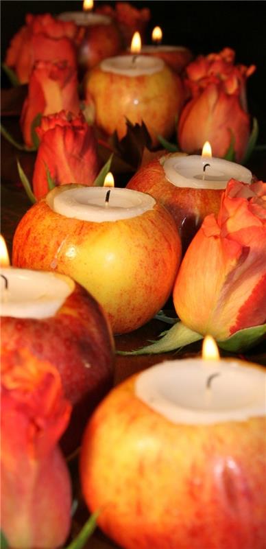 izpraznjena jabolka, napolnjena s svečami, rdečimi tulipani, ki jih obdajajo, ideje za postavitev mize