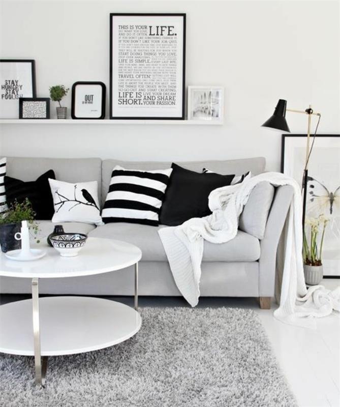 Mobili soggiorno moderni, tavolino rotondo bianco, mensola con quadri