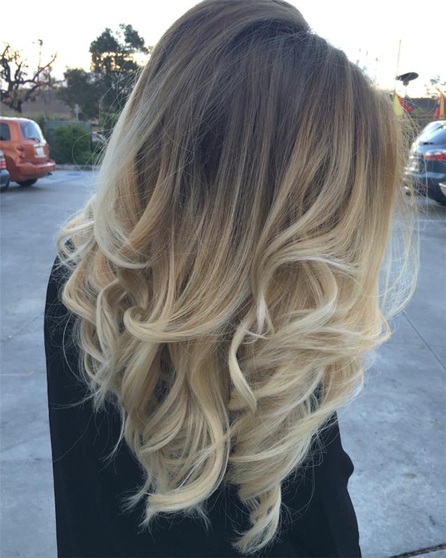 blondinka ombre balayage, model ženska črna jopica, pričeska z ravnimi lasmi s kodranimi konicami v blondinki