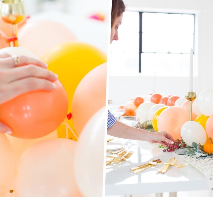 pripūsti balionai šventiniam stalui papuošti, aukso spalvos indai, baltas stalas, pastelinės spalvos balionai