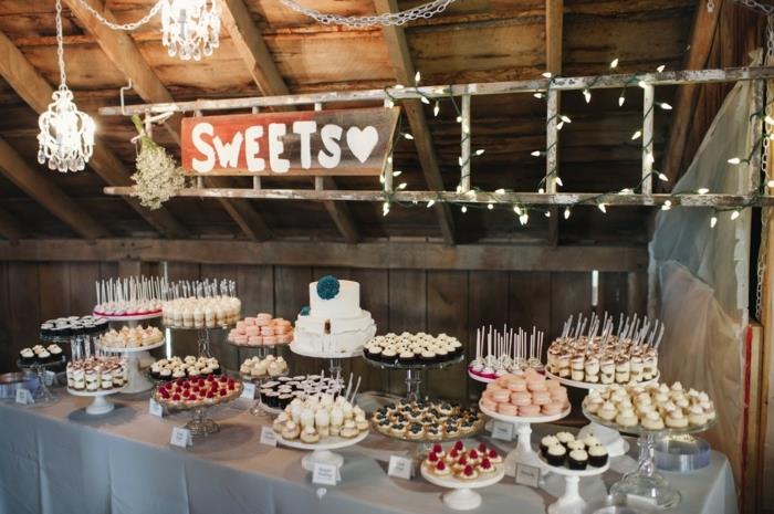 poročna sladkarija, sladice, amkaroni, torte, piškoti na poročni torti, eleganten lestenec, svetlo venec in ozadje v kmečkem dekorju