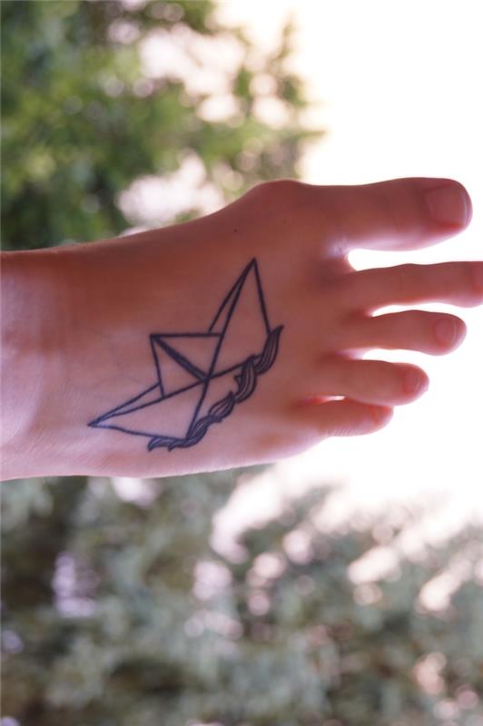geometrijska tetovaža papirnatega čolna, ki plava na valovih