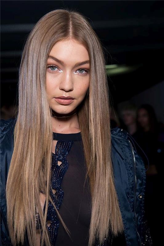 açık altın kahverengi, kahverengi kökleri ve bakır sarısı vurguları olan uzun ve düz saçlı Gigi Hadid