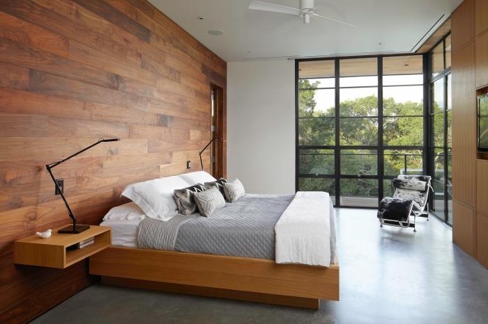 suaugusiųjų miegamojo apdaila su betoninėmis grindimis ir medinėmis lentų sienomis, modernaus stiliaus suaugusiųjų miegamasis su kaimiškais akcentais