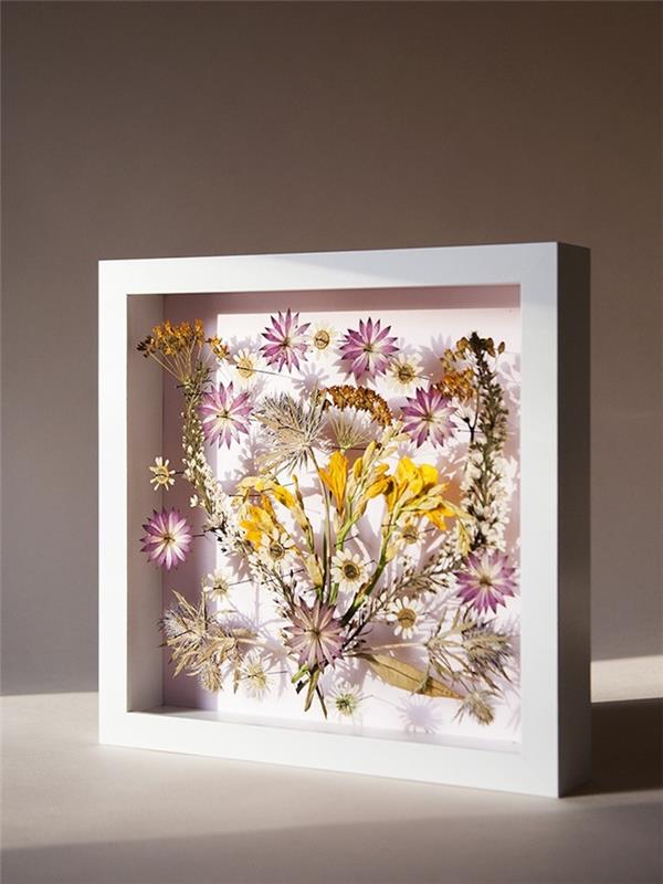 izvirna ideja za ročno pomladno dejavnost z uokvirjenim stisnjenim cvetjem, lepa miza s suhim cvetjem z belim okvirjem