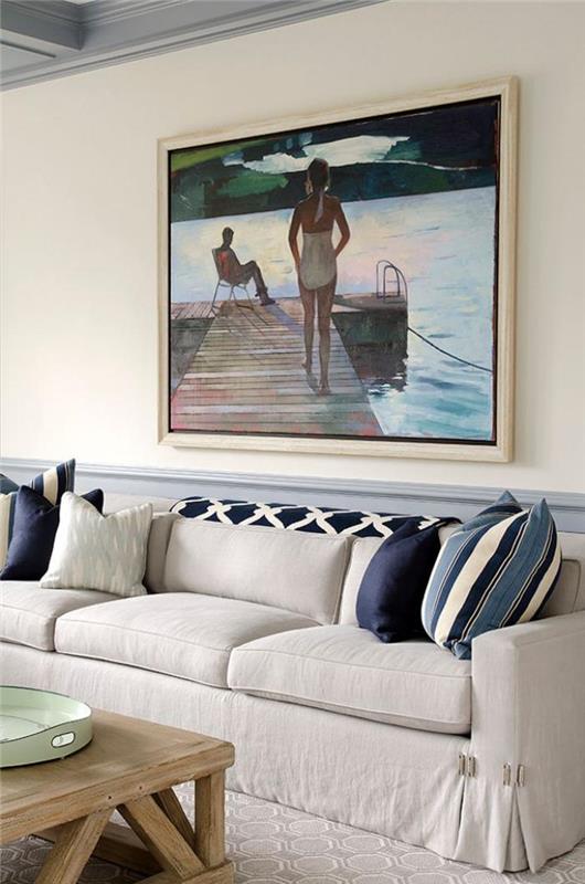 smėlio spalvos sofa-stalas-žaliavinėje medienoje ir meninė tapyba