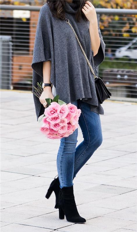 krzneni plašč v sivi kombinaciji s kavbojkami in črnimi škornji ženska drži šopek vrtnic