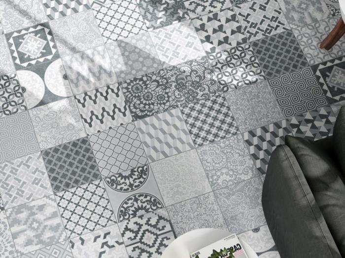 kuhinjske cementne ploščice na tleh z rastlinskimi in geometrijskimi vzorci v beli in svetlo sivi barvi