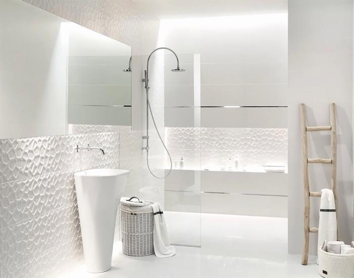 beyaz kabartmalı banyo karoları, beyaz duvarlı penceresiz ıslak oda dekoru ve paslanmaz çelik kaplamalı mobilyalar