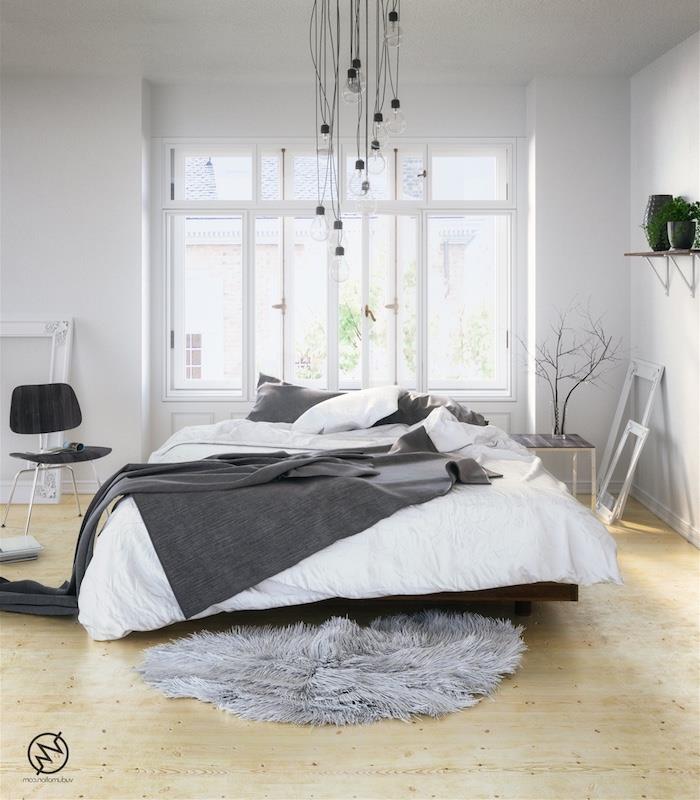 dekoriranje spalnice s sivo -belim posteljnino, lahkim parketom, obešanjem v žarnicah, belimi okvirji, sivo krzneno preprogo
