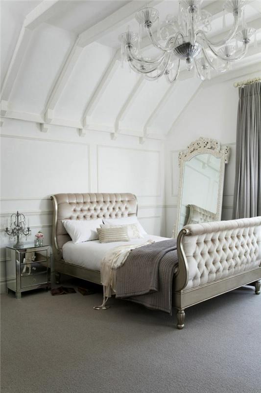 barva spalnice za odrasle, strop z lesenimi tramovi, kristalni lestenec, oblazinjeno vzglavje, siva preproga