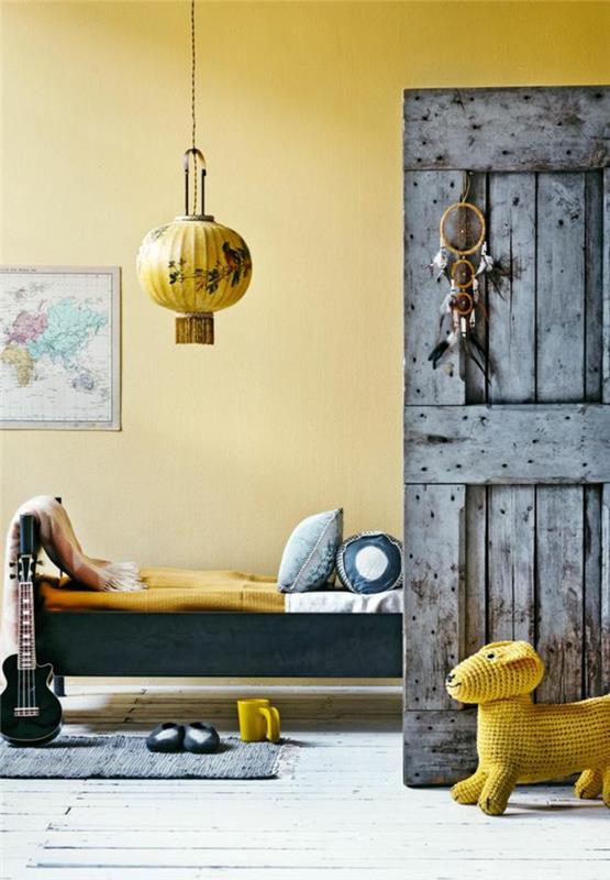 altın sarısı hardalla boyanmış vintage tarzı bir çocuk odası, eskitme efektli rustik ahşap kapı, hardal rengi dekor trendi