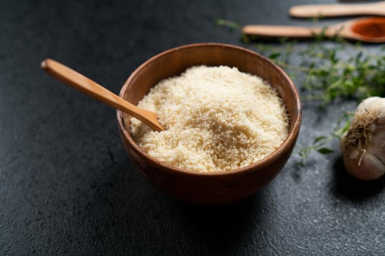 Ciotola di legno con parmigiano grattugiato, krompir al forno particolari