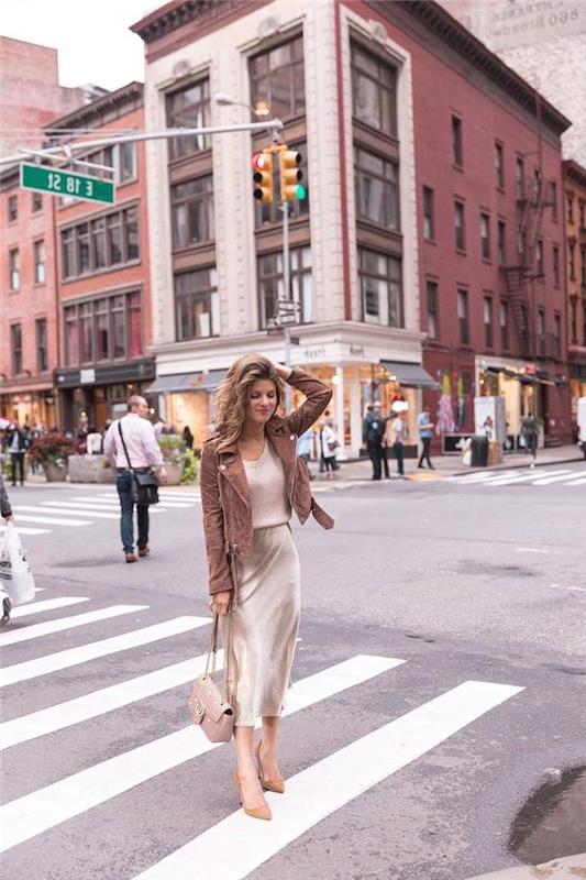 ženska, ki stoji na prehodu, v belem svilenem krilu in rjavi jakni, napoved modnega trenda 2019, prometna mestna ulica