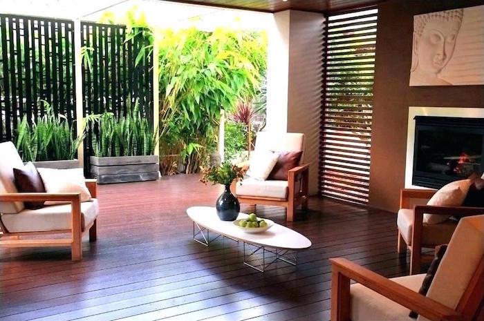 lauko sodo baldai parketo terasoje su egzotišku dekoru ir siauru interjero mediniu aptvaru, atskirtu nuo išorės