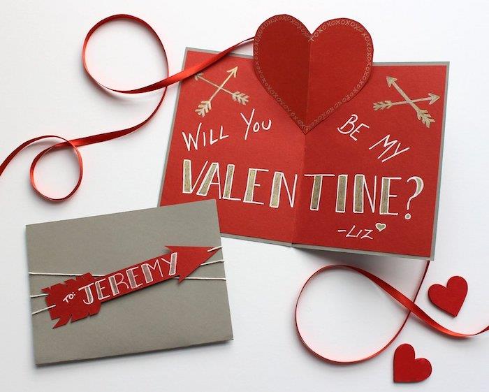 su Valentino diena, raudonos, pilkos ir auksinės spalvos atvirukas su tekstu ir mažais piešiniais, rodyklė ir popierinė širdelė