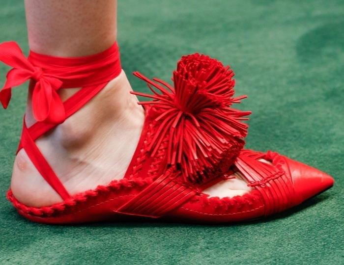 kako se obleči v skladu s trendi, izberite par izvirnih ženskih ravnih čevljev v rdeči barvi s pomponi in trakom