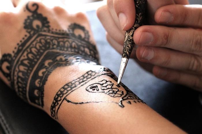 tetovaža črne kane, tehnika risanja na koži s črno kano, tetovaža na rokah za ženske
