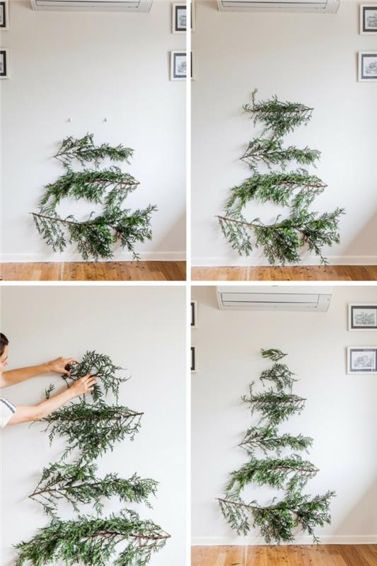 minimalist ve doğal tarzda el yapımı Noel dekorasyonu, bir Noel ağacı oluşturmak için duvarda asılı doğal yeşil dallar