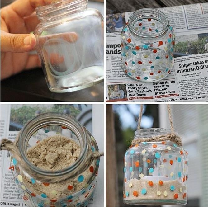 reciklirni stekleni kozarec, pretvorjen v preprost svečnik, napolnjen s peskom in okrašen s pisanimi pikami s svečo, enostavno preusmerjanje predmetov