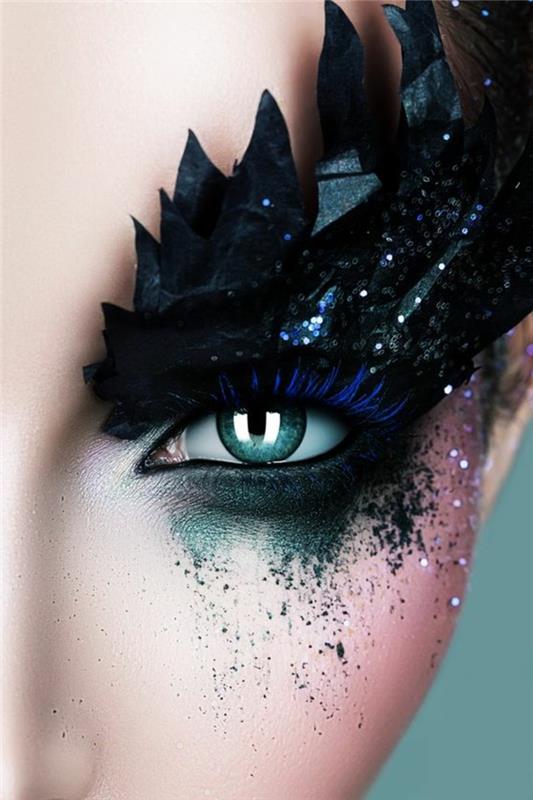 ekscentrična ličila za modre oči v električno modri zeleni in črni barvi z bleščečimi modrimi obrvi, ki se končajo z okraski iz črnega ptičjega perja