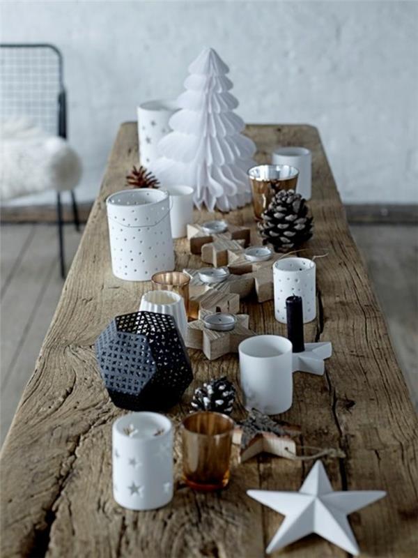 Skandinaviškas stalas iš žalios medienos, balto popieriaus medis, geometrinis žvaigždės formos žvakidė, kankorėžiai