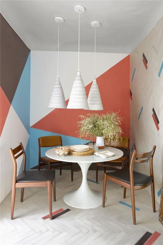 Dekoracija jedilnice majhna bela okrogla miza stol slikanje lesa trikotnik oranžna barva viseča svetilka