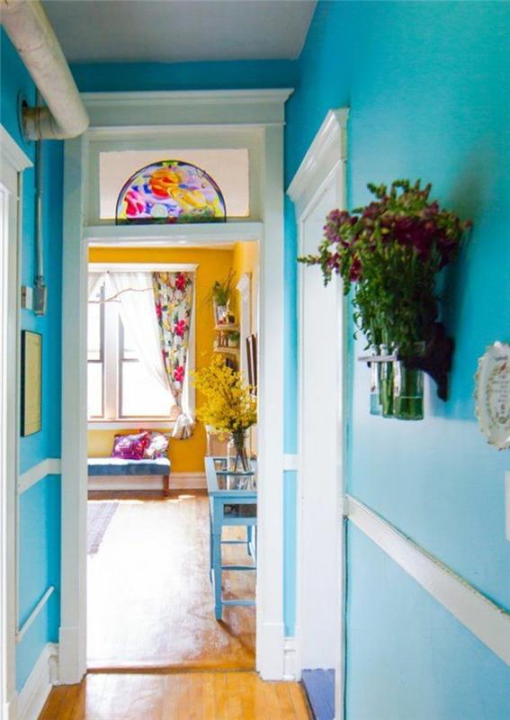 mavi ve sarı dekor fikri, mavi duvar boyası koridor ve hardal sarısı oturma odası, çiçek desenli dekorasyon, açık renkli ahşap döşeme
