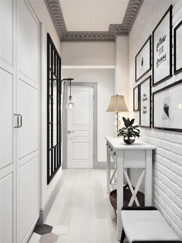 idėjos įėjimas juodai baltas su plytelėmis išklotomis grindimis su geometriniais raštais aviliai baltoje, juodoje ir pilkoje, baltų plytų sienoje
