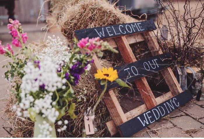 Poročni dekor DIY, lesena paleta z besedilom dobrodošlice za goste, šopek podeželskega cvetja, bala slame