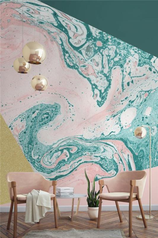 Skandinaviškas dekoras modernioje svetainėje, vandens žalia ir rožinė sienų spalva, auksiniai rutuliniai pakabinami žibintai, medinė kėdė, rožinės kėdės pagalvėlės, rudas parketas, pilkas kilimas