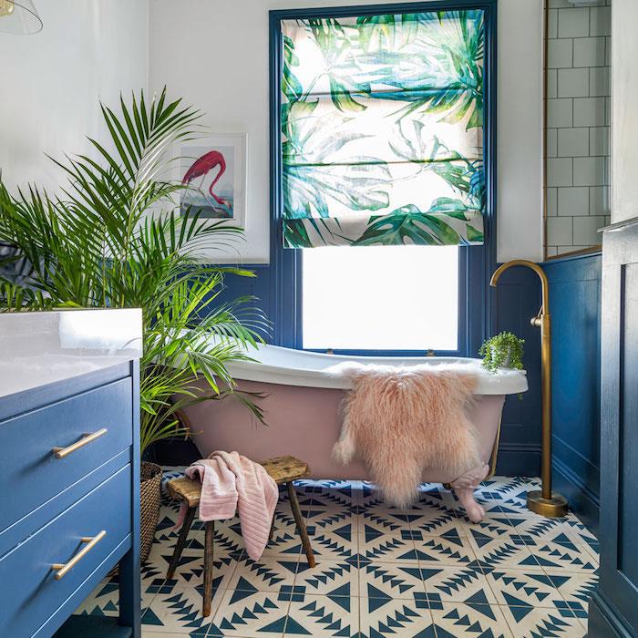 modro -bela stena v kopalnici z modrim kopalniškim pohištvom in rožnato kadjo, kopalnica z zelenimi rastlinami, deco cocoon