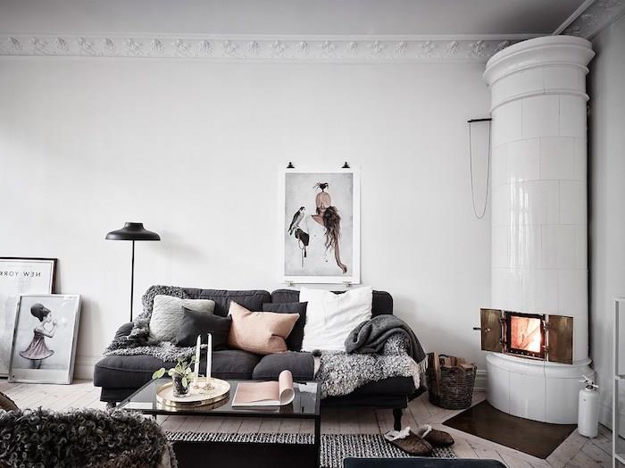 decocoon decocoon ideja, trend hygge, kavč s sivim ogljem z blazinami, siva, črno -bela, siva krzna, črna mizica, beli kamin