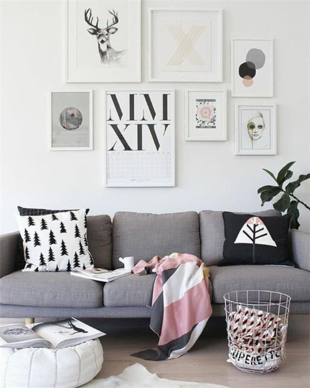 modernus svetainės dekoras, skandinaviškai pilka sofa, rožinė ir balta pledas, pagalvėlės su skandinaviškais raštais
