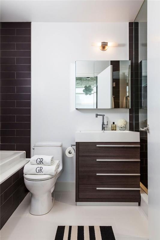ideja postavitve kopalnice z belimi stenami in stropom z odsekom stene v rjavih opečnih ploščicah in omarico