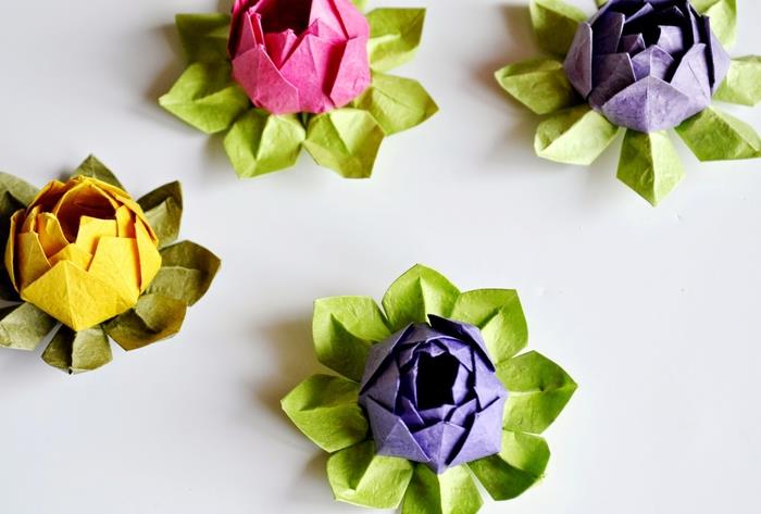 lotoso gėlių origami modelis iš prašmatnaus spalvoto popieriaus, idealiai tinkantis gėlėtam ir linksmam stalo dekoravimui