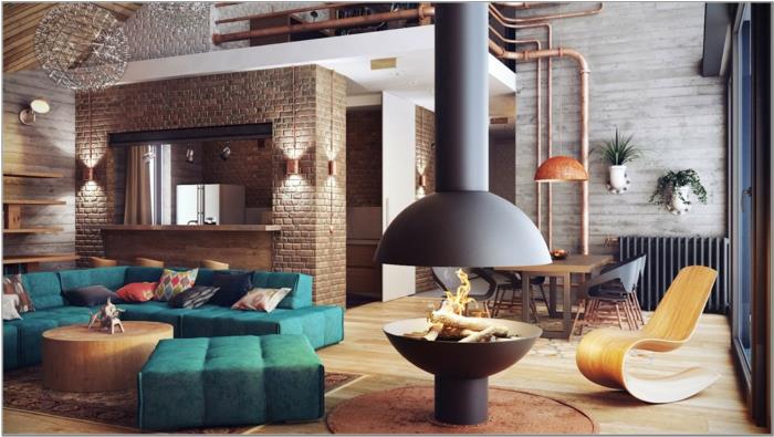 pramoninio deko idėja, medinės lubos, žalia sofa, apvalus kavos staliukas, židinys, žali augalai, atviri vamzdžiai