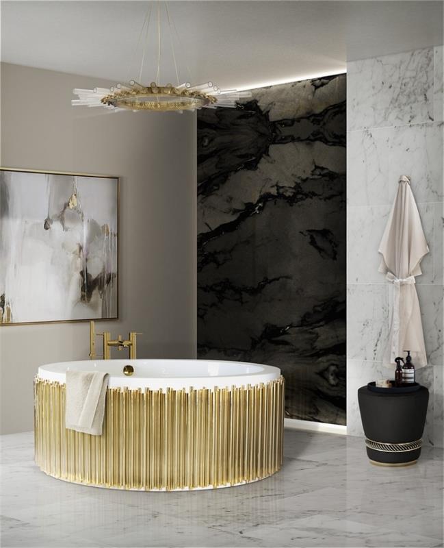 sodobna postavitev kopalnice s sivo barvo za stene in delno oblogo iz belega in črnega marmorja, kadjo ter belo in zlato svetilko