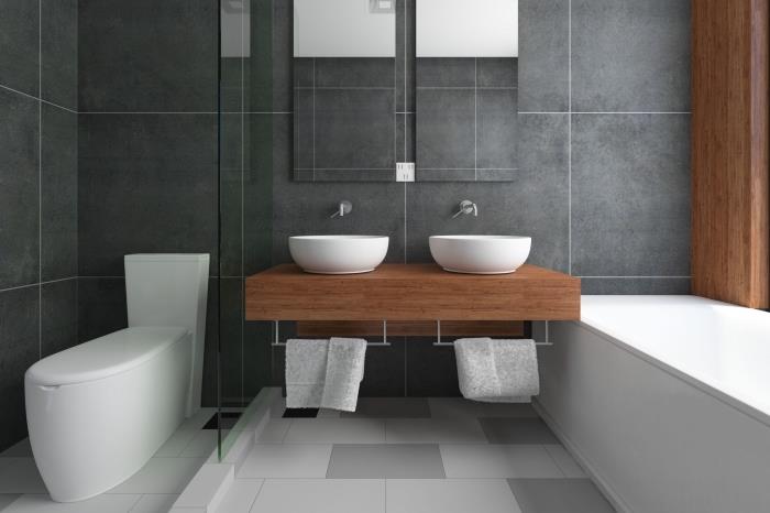 model kopalniških ploščic v antracitno sivi barvi na stenah v kombinaciji z belimi in svetlo sivimi talnimi ploščicami