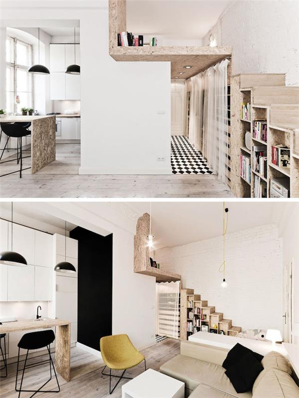studijos išdėstymas su mediniais laiptais su saugykla po laiptais, juodai balta virtuvės puošmena su juodomis pakabomis virš centrinės salos medinio stalo, smėlio spalvos sofa