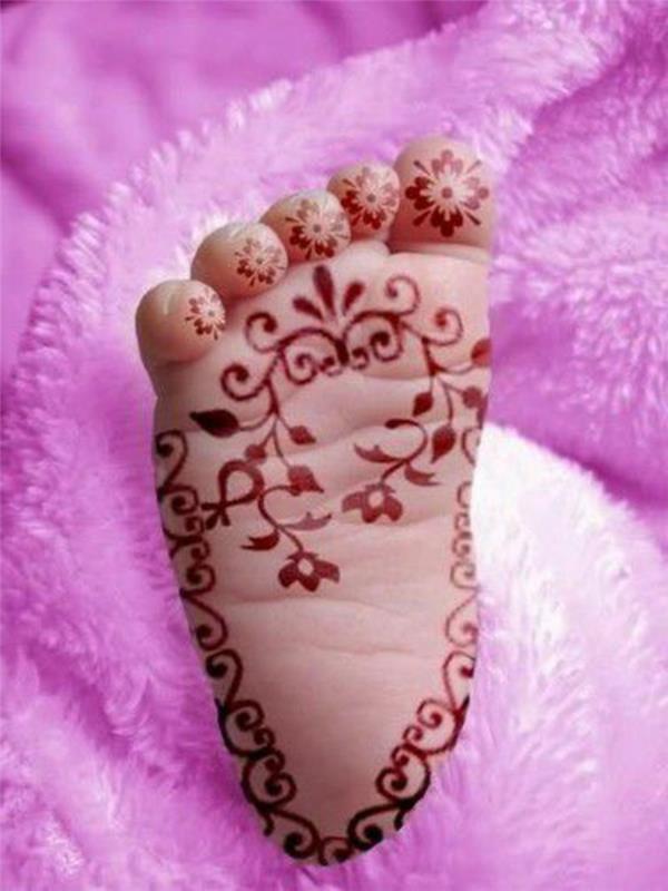 kına tasarımı, bitki dövmeli küçük bebek ayağı, ayak parmaklarında simetrik çiçek tasarımları