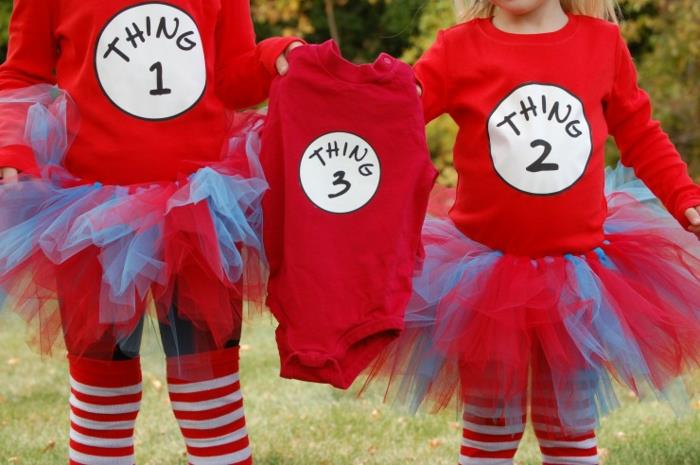 orijinal hamilelik duyurusu, kırmızı giymiş iki kız kardeş 3 numaralı kıyafetleri tutuyor