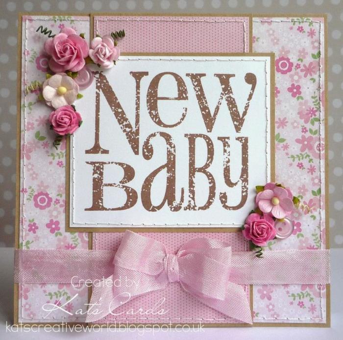 voščilnica za novorojenčka, papirnate rože, roza trak, kos papirja, pritrjen na papir