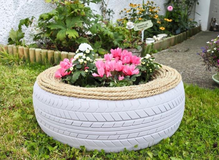 vrtna dekoracija s pnevmatiko, model domačega sejalnika z reciklirano pnevmatiko in vrvjo, mali vrtni dizajn z lončki za rože