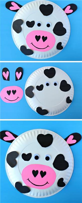 kravji obraz iz bele papirnate plošče, okrašen z rožnatimi in črnimi izrezi iz papirja, z lepljivimi očmi