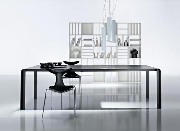 beyaz bir odada siyah masa ve sandalye seti