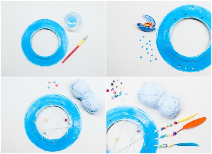 çocuk rüya kapanı modeli beyaz iplik ağ ile mavi yeniden boyanmış kağıt tabakta, renkli boncuklar ve tüylerle süslenmiş